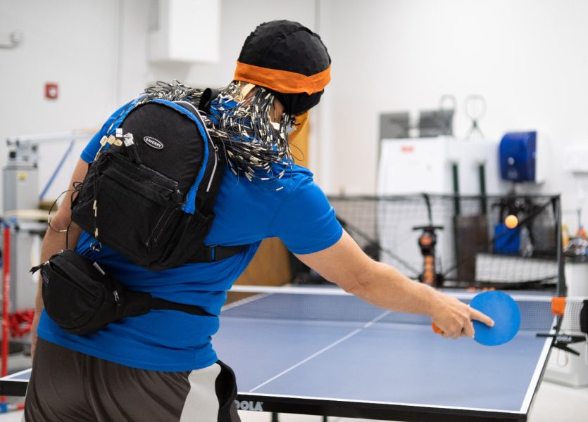 Human Brain Reacts Differently to Table Tennis Matches Against Human and Machine Opponents